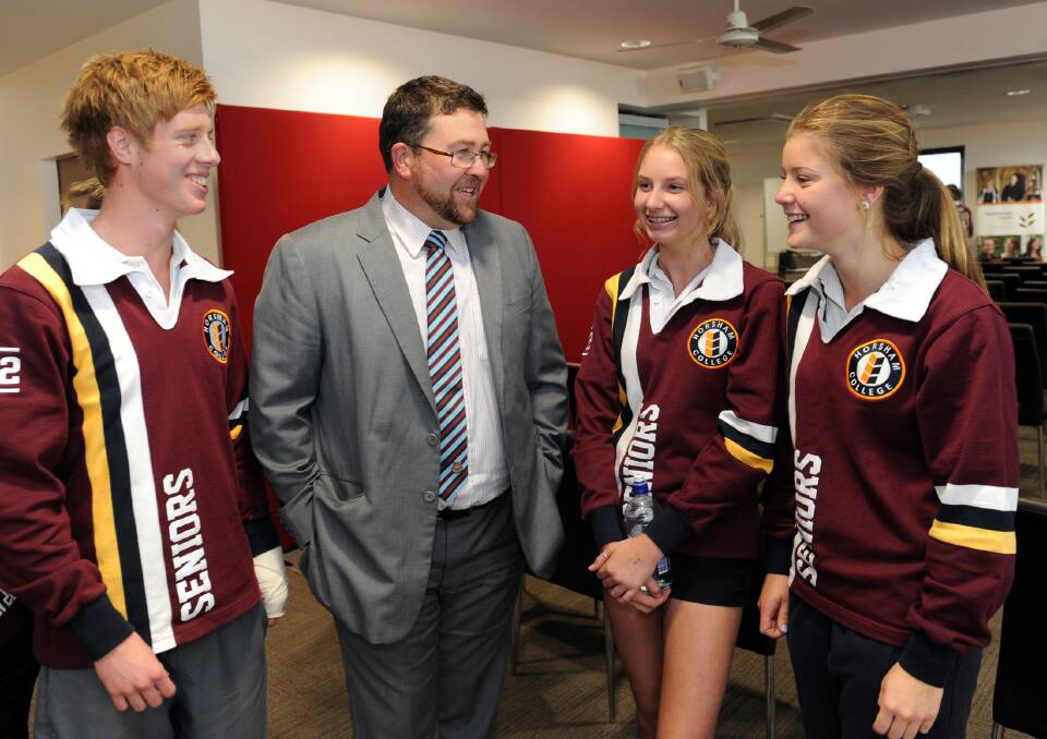 ON THE JOB: Horsham College acting principal Rob Pyers chats to year 12 students Beau Cross, Chelsea Drum and Kobi Batson on his first day at the school. Picture: PAUL CARRACHER