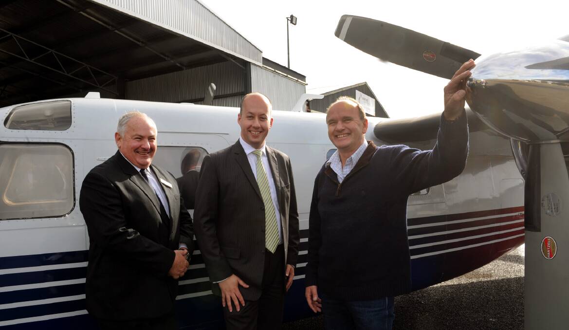 FLYING HIGH: Northern Grampians Mayor Kevin Erwin, Aviation Minister Gordon Rich-Phillips and AGA Service's Rob Boschen at the announcement of money for the Stawell Airport upgrade. Picture: PAUL CARRACHER