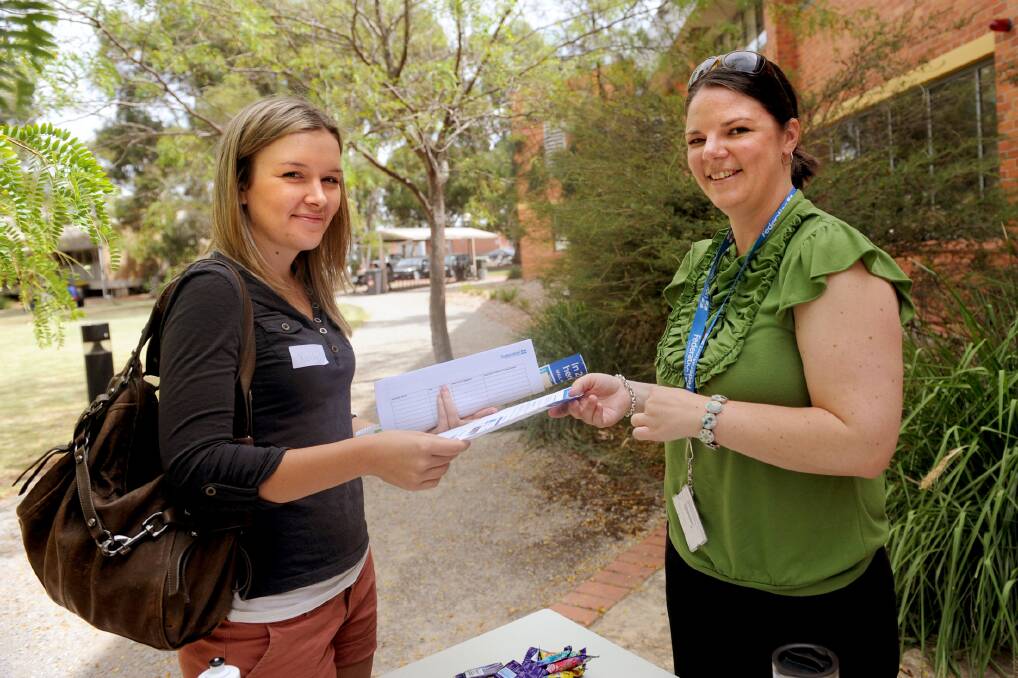 FEBRUARY: Fed Uni careers employment officer Hayley Spratling shows Kathy Sturdy a few notes at orientation week.