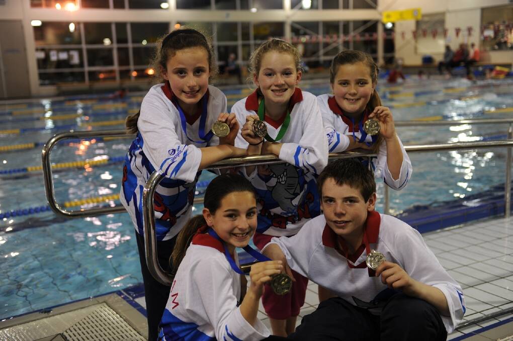 SHARKS SUCCESS: Horsham Swimming Club’s Eloise Wills, Claudia McAuliffe, Lily Bolton, Matthew Ough and Alyssia Jenkins, clockwise from back left, show off the rewards of their hard work at the 2014 Winter Swim Series in Hamilton. Picture: PAUL CARRACHER