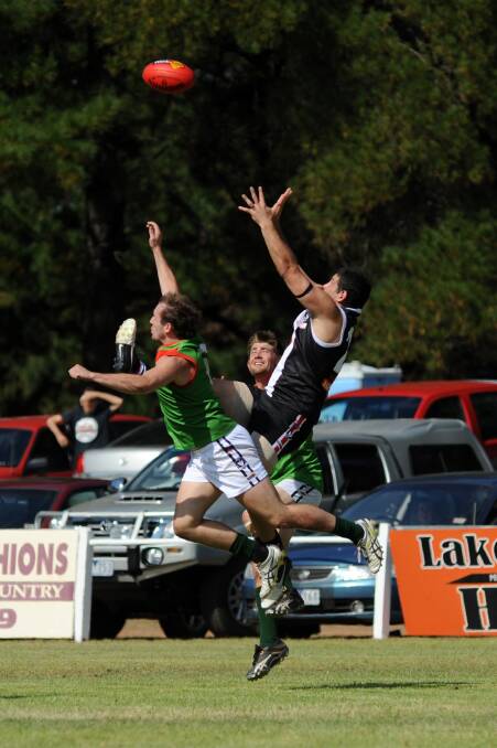 Edenhope-Apsley's Brendan Fevola takes a screamer over Noradjuha-Quantong's Brady King and Brad Couch.