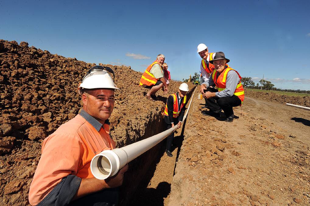 2011: Jack Farrugia lays the last pipe in the Wimmera-Mallee Pipeline at Lubeck with, back, Peter Vogel with Lily Peters, Bruce van Every, Jeff Rigby and Barry Clugston. Picture: PAUL CARRACHER