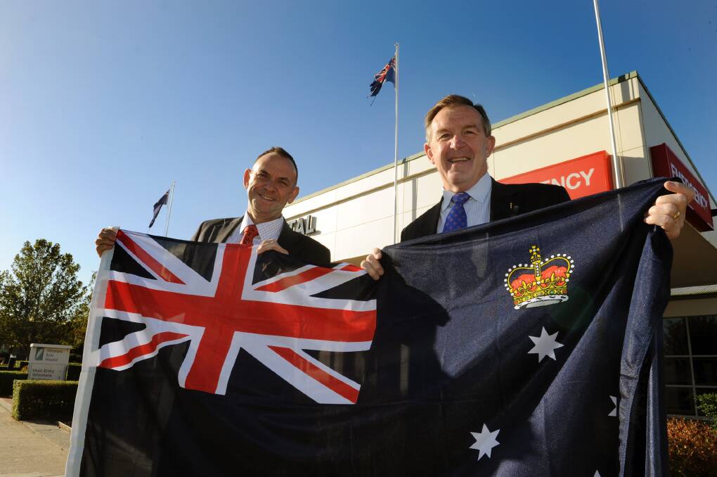 Wimmera Health Care Group chief executive Chris Scott and Member for Lowan Hugh Delahunty with Victorian flag at Wimmera Base Hospital earlier in the year. Picture: PAUL CARRACHER
