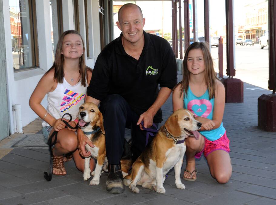 JANUARY: Steve Olver, with daughters Abbey, left, and Lily, with dogs Buster and Bella.