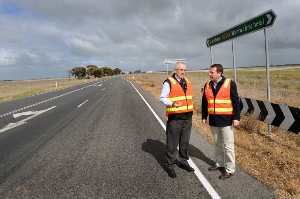 ROAD UPGRADE: VicRoads maintenance team leader Daryl Sinclair and Member for Mallee Andrew Broad discuss the Henty Highway at Kewell. Picture: PAUL CARRACHER
