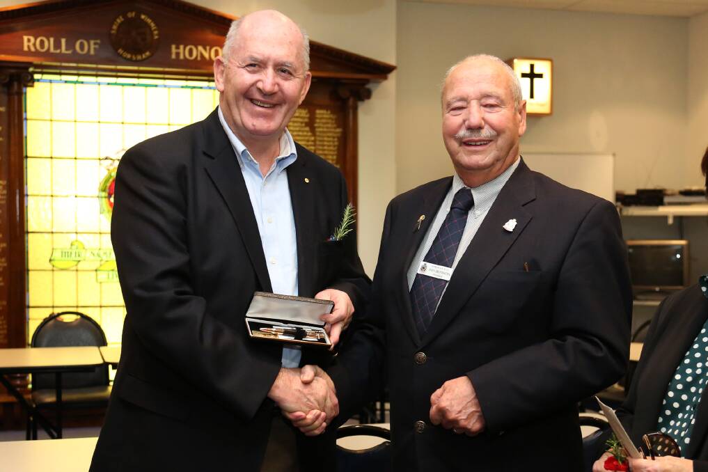 Sir Peter Cosgrove thanks Horsham RSL president John Brondsema for a gift on Wednesday. Picture: THEA PETRASS