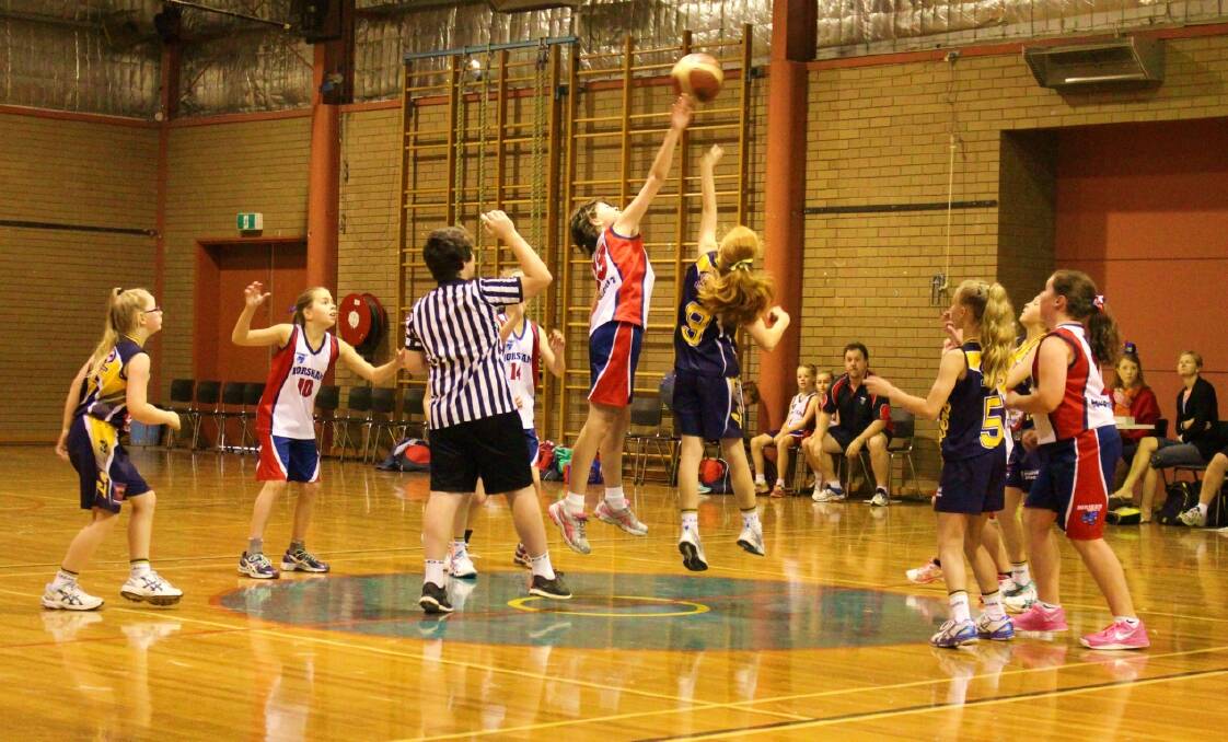 FLYING HIGH: Horsham basketballer Jasmine Johns leaps over the top of her opponent to win a tip-off at her side’s under-12 girls tournament in Colac at the weekend.