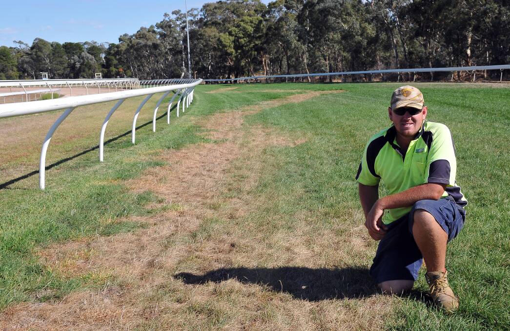 Stawell Racing Club track and facilities manager Chris Grayham inspects a section of the track that has possibly been poisoned by vandals. Picture: STAWELL TIMES-NEWS