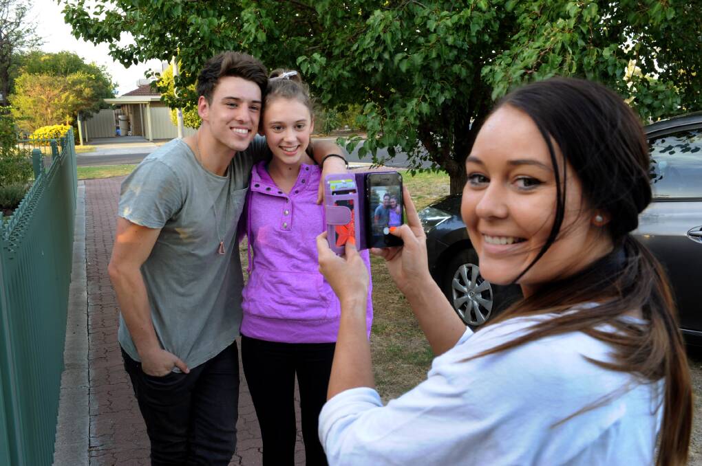 FEBRUARY: X Factor runner-up Taylor Henderson with fan Annie Surridge. Taylor's girlfriend Meg O'Connor takes a photo.
