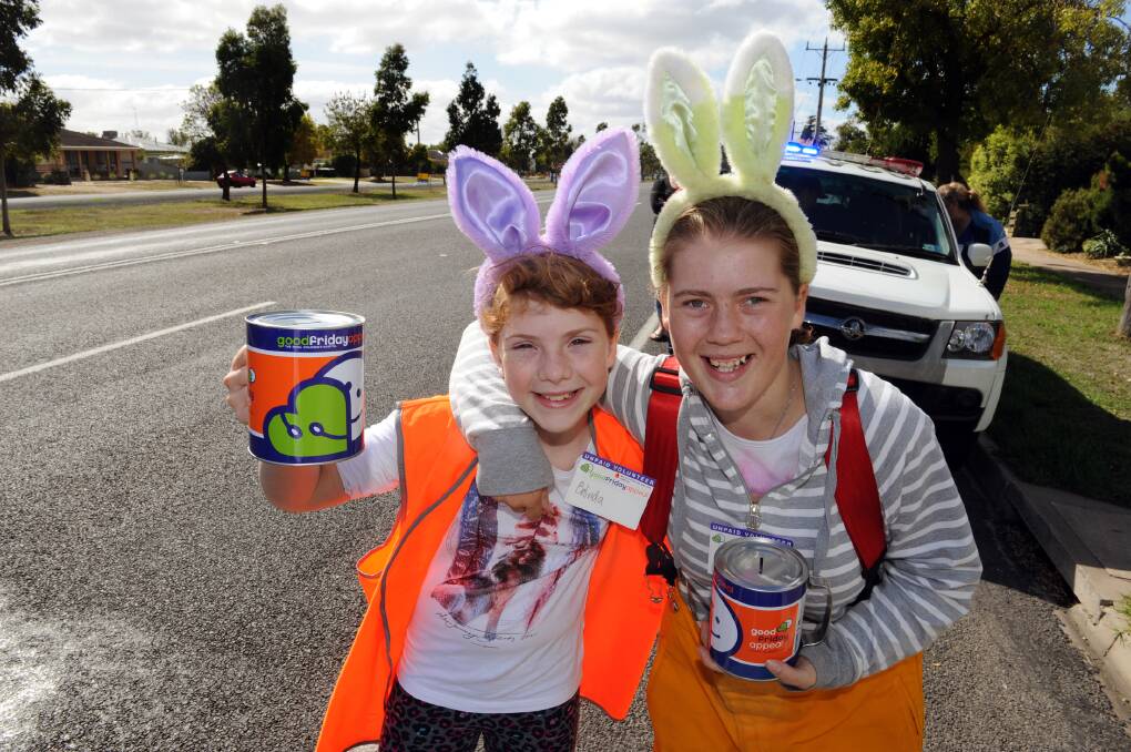 RAISING SPIRITS: Belinda Ziersch, 11, and Sarah Ziersch, 16, are all smiles as they collect for Horsham Fire Brigade’s Good Friday Appeal effort. Pictures: PAUL CARRACHER