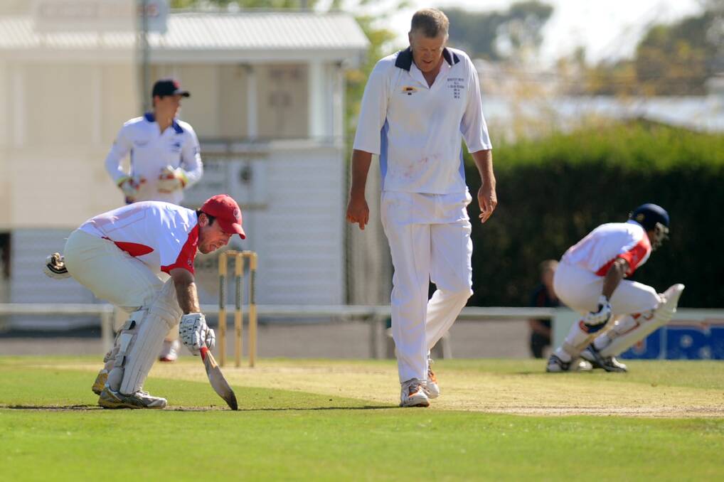 Homers batsmen Lachie Jones and Sandy Hodge with Rup-Minyip's Paul Morgan in the middle during the Rup-Minyip v Homers A Grade grand final.