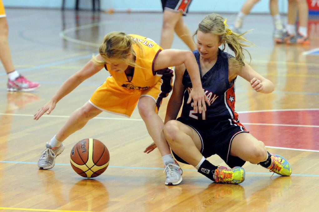 FINALS BOUND: Stawell Wildcat Chelsea Hall and Horsham Hornet Aily McAuliffe battle for the ball at Horsham Basketball Stadium earlier this month. Both teams will contest Country Basketball League semi-finals on Saturday, with the Wildcats travelling to Portland and the Hornets away to Warrnambool. Picture: PAUL CARRACHER