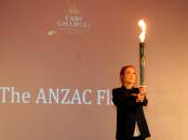 Horsham College captain Maddison Crough accepts the Anzac flame at Horsham’s Camp Gallipoli on Friday night. Pictures: SAMANTHA CAMARRI