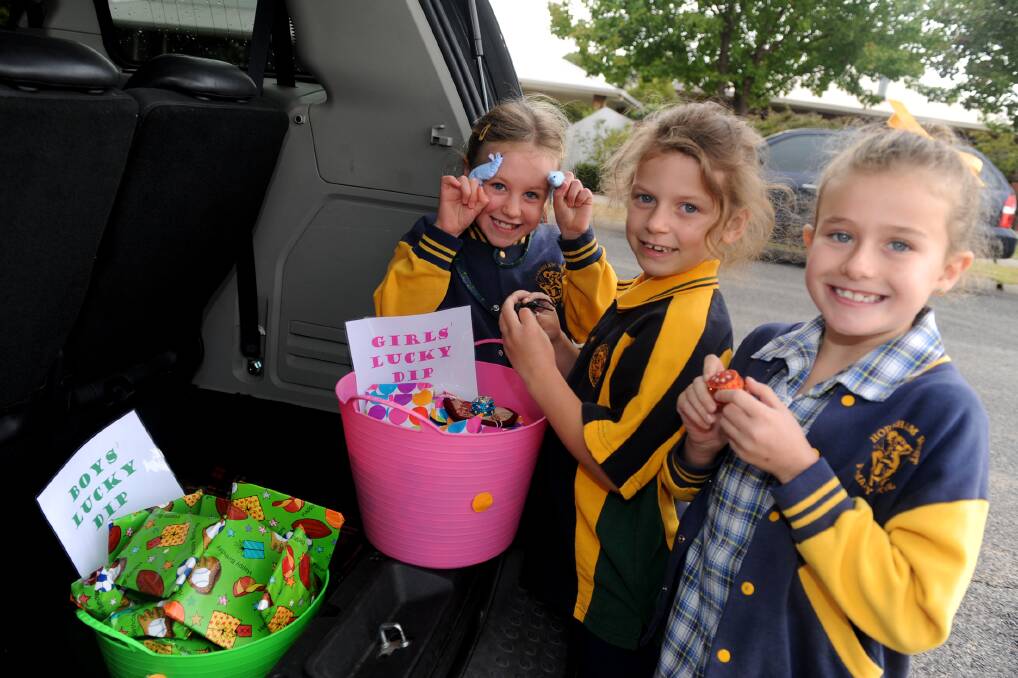 GOODIES GALORE: Tiani Grosser, Sophie Quick and Madison Scott get ready for the Horsham West Primary School parents club’s car boot sale fundraiser. Picture: SAMANTHA CAMARRI