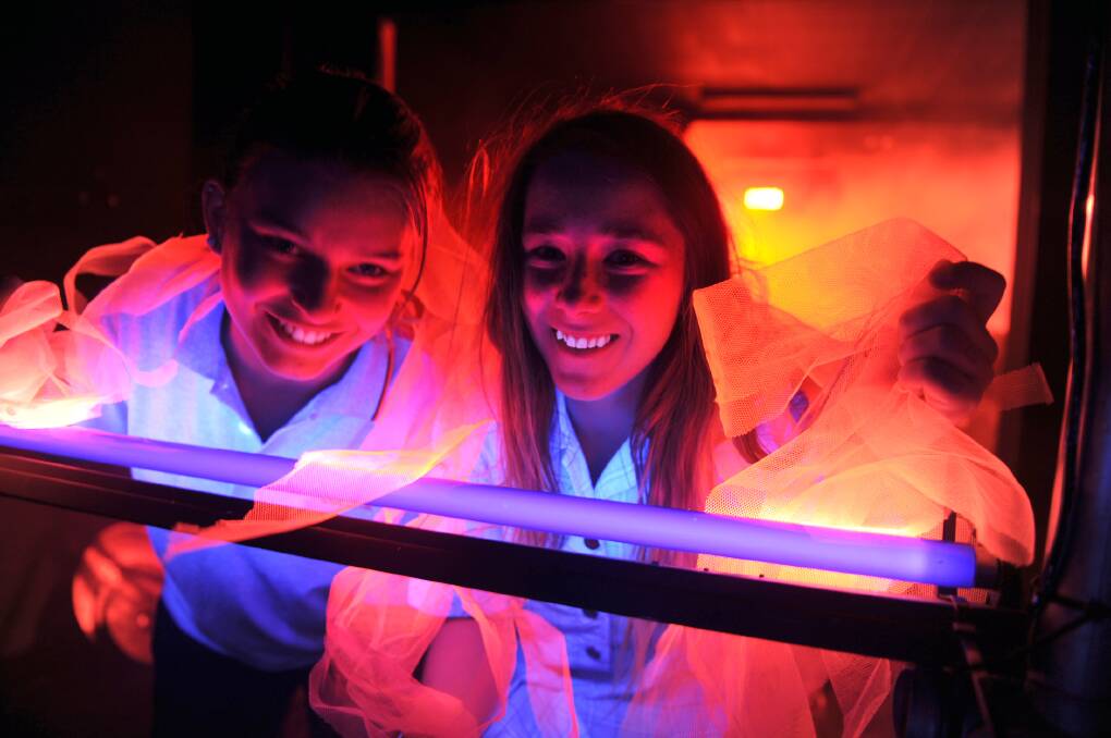 READY TO GLOW: Kyla Lawes and Molly Parfett-Oliver prepare for Horsham Nexus Youth Centre’s fluoro disco. Picture: PAUL CARRACHER
