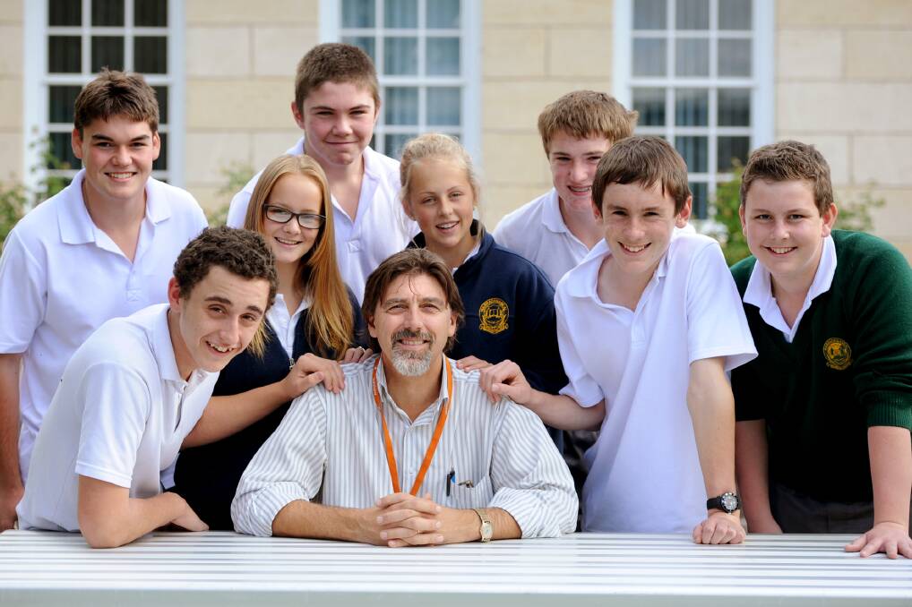 GLOW OF SUCCESS: Warracknabeal Secondary College students congratulate principal Tony Fowler for winning two awards last week. He is also a finalist for Secondary Principal of the Year. Picture: SAMANTHA CAMARRI