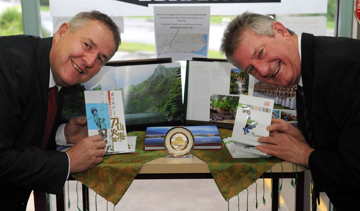 CHINESE CULTURE: Horsham Mayor David Grimble and chief executive Peter Brown at the Nujiang prefecture display at Horsham and Grampians Visitor Information Centre. Picture: PAUL CARRACHER