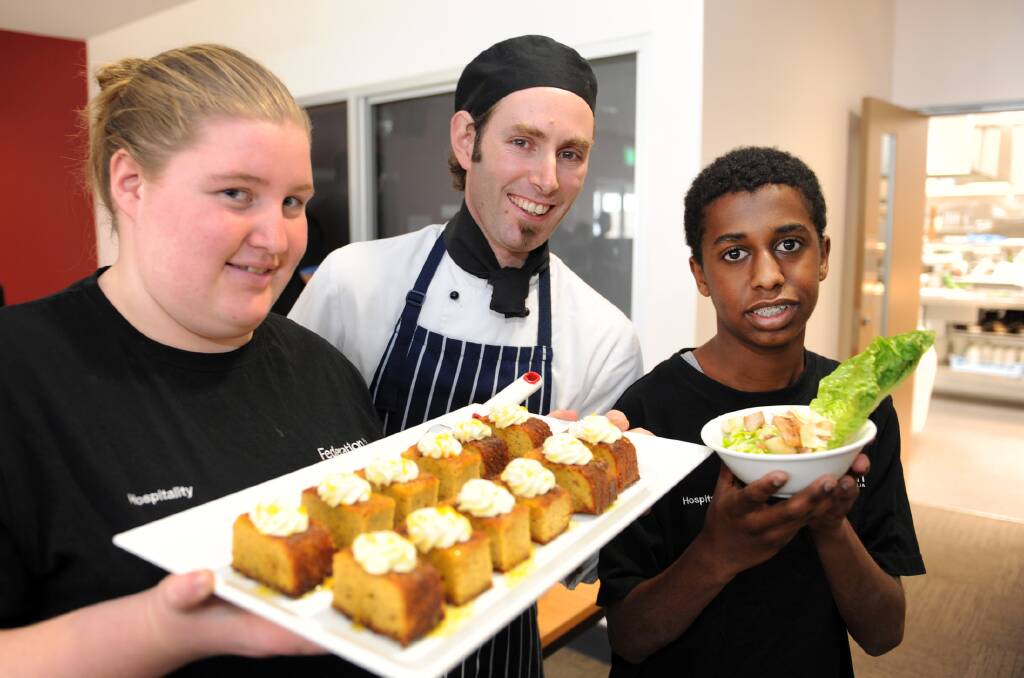COOKING UP A STORM: Kathleen Sanders, chef instructor Jamie Mahony and Tom Hobbs prepare for Wednesday lunch service at Wimmera Trade Training Centre’s Horsham College campus. Picture: PAUL CARRACHER