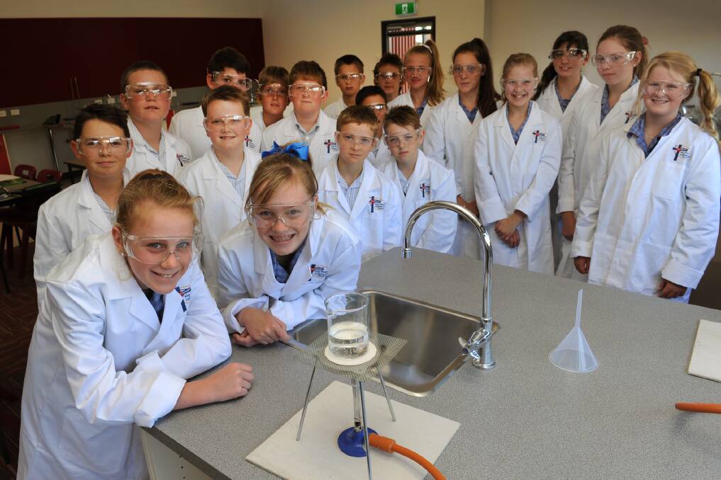 SETTLING IN: Horsham's Holy Trinity Lutheran School inaugural year seven students Sarah Barber and Abbey Hawker and classmatess enjoy studying science in their new campus.