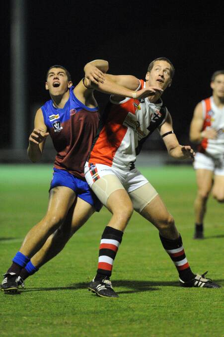 Demon Billy Carberry and Saint Michael Rowe lock horns during the clash.