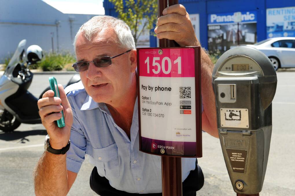 EASY PARKING: Horsham Rural City Council enforcement officer Garry Kennett showcases the new EasyPark app for Horsham’s parking meters. Picture: PAUL CARRACHER