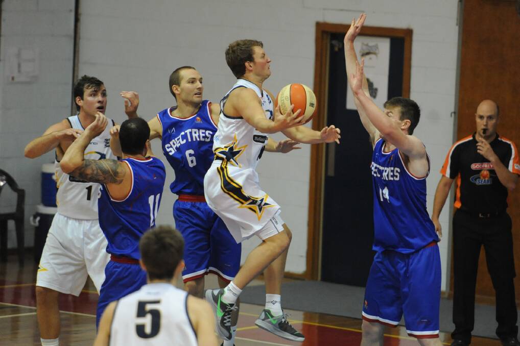 TO THE HOOP: Ballarat’s Sean Massey attacks the rim while surrounded by Nunawading defenders.