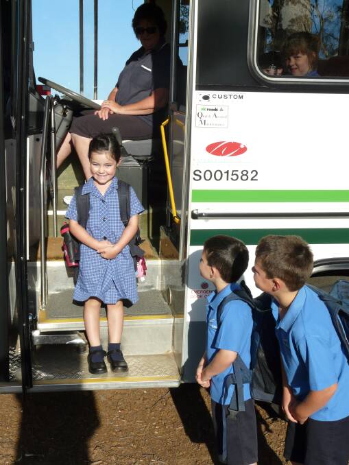 Mia Rees, 5, boards the school bus at Telangatuk East for her first day of school at Balmoral Community College, while her brothers Alex, 7, and Joel, 9, look on.