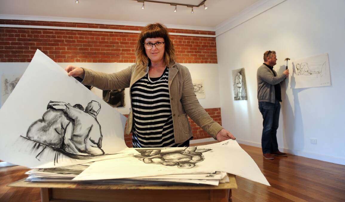 LIFE INSIGHT: Horsham Regional Art Gallery education officer Debbie Moar and director Adam Harding prepare Natimuk’s Goat Gallery for the opening of a life drawing exhibition on Friday night. Picture: PAUL CARRACHER