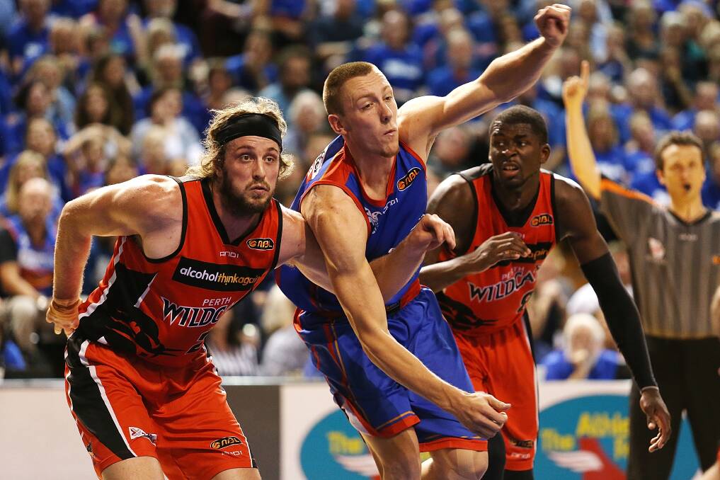 ON THE BALL: Mitch Creek, right, fights against Wildcat Jesse Wagstaff in the NBL grand final series last month. Creek has signed a new deal with the team. Picture: GETTY IMAGES