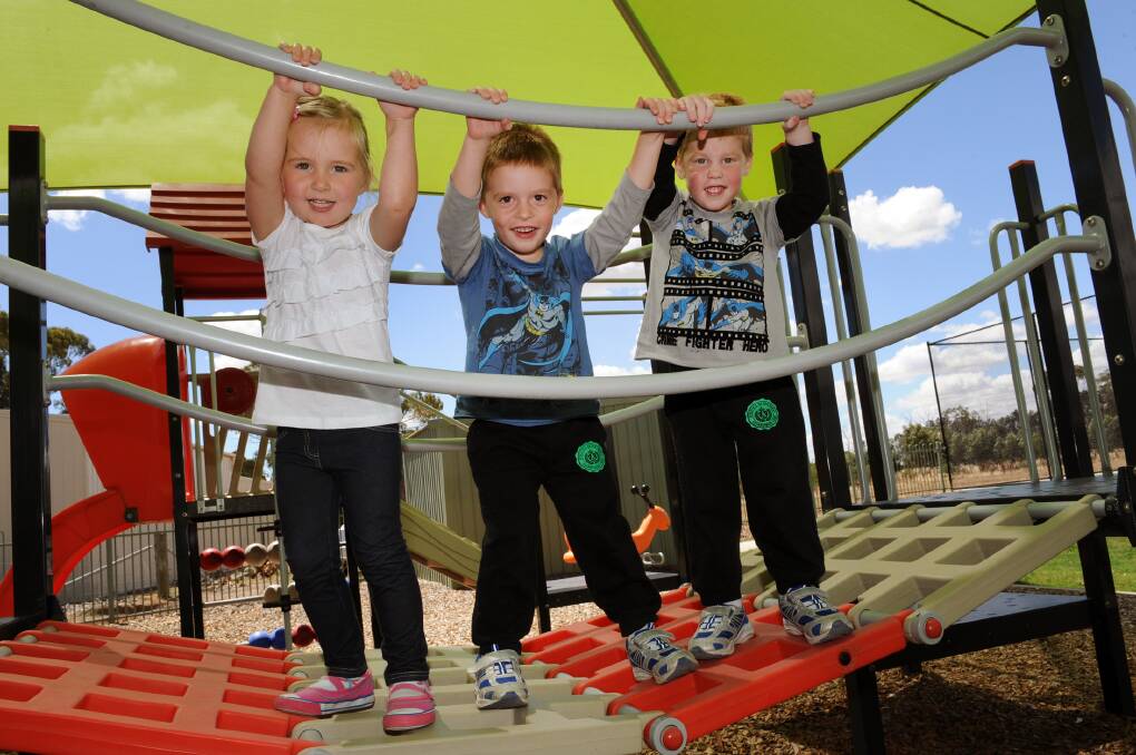 HANGING OUT: Haven Community Playgroup members Jayda Mills, 3, and twins Harry and Jack Toet, 3, make the most of the playgroup’s new playground. Pictures: PAUL CARRACHER