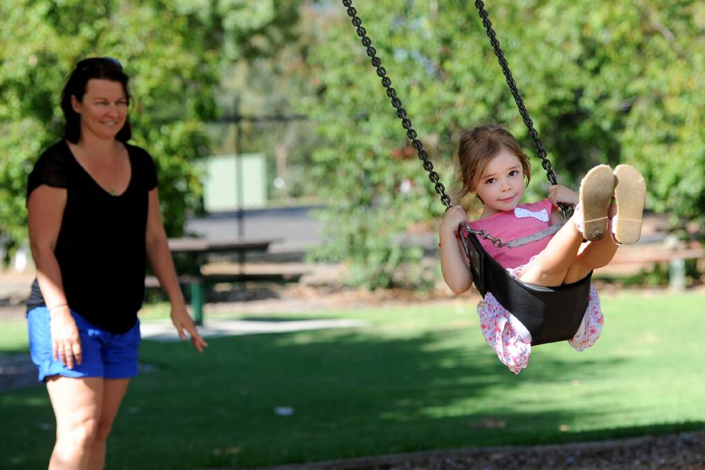 SMOKE FREE: Lucy Pietsch, 4, enjoys a swing at Horsham Botanic Gardens on Tuesday, as Tracey Pitts looks on. Picture: SAMANTHA CAMARRI
