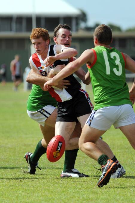 Edenhope-Apsley's William Middleton is tackled by Noradjuha-Quantong's Adam Jolley. 