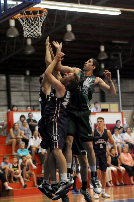 TOUGH CONTEST: Horsham Hornets forward Jono Lovel competes under the ring with Colac centre Liam McInerney in the Hornets’ five-point semi-final win at Horsham Basketball Stadium. The Hornets will face Mt Gambier at home in Saturday’s grand final.