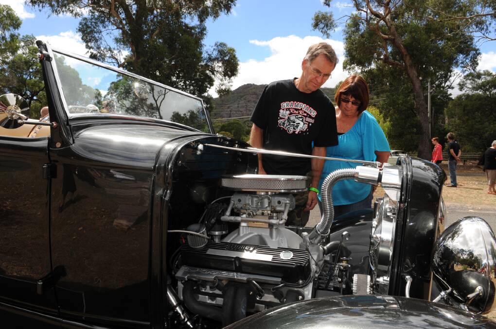 LOOKING: Adelaide's Daryl and Heather Anderson check out everything on show at the Old Skool Hotrod and Custom Club show and shine at Halls Gap on Sunday.