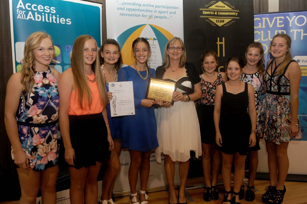TEAM OF THE YEAR: Helen Hannan presents the award to St Brigid's College's under-15 volleyball team.