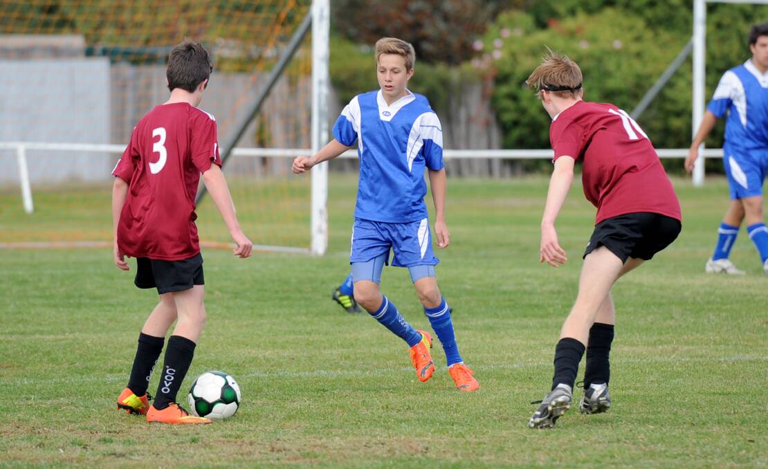 Under-15 player Reuben Macchia, centre, in action for Horsham Falcons. Picture: SAMANTHA CAMARRI