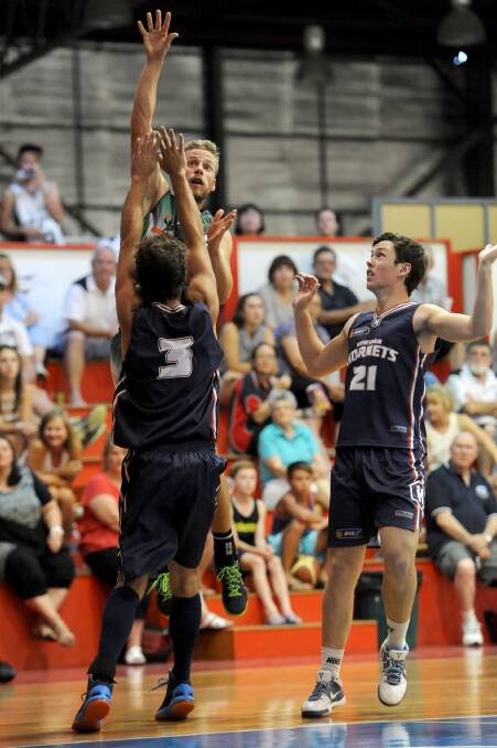 SHOT: Colac's Marcus Larcombe goes above Horsham Hornets' Tim Friend and Ben Lakin.