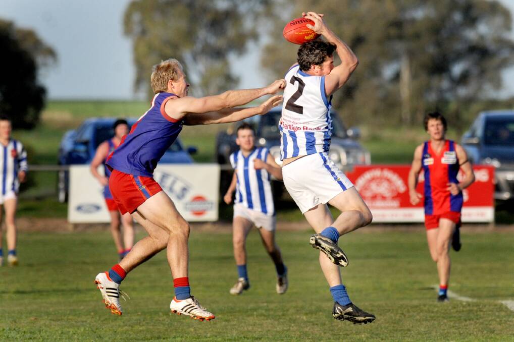 GOOD EFFORT: Harrow-Balmoral's Brent Penny takes the mark despite pressure from Rupanyup's Scott Reading. He has been awarded HDFNL life membership after notching up 300 games. Picture: SAMANTHA CAMARRI