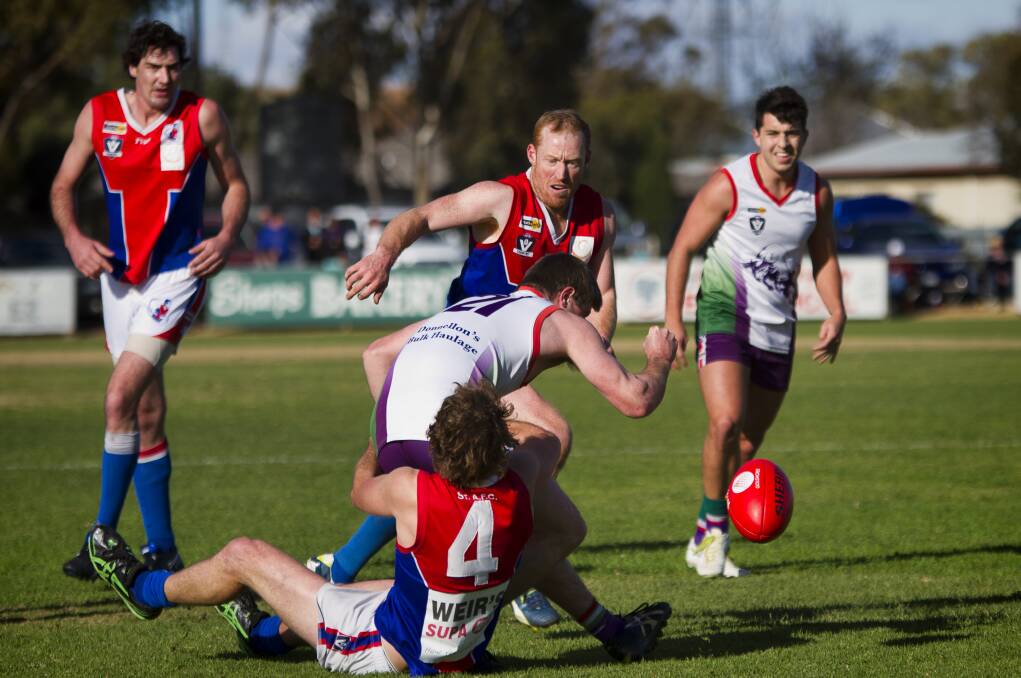 St Arnaud skipper Ben Batters claims Birchip-Watchem’s Connor Walsh in a strong tackle on Saturday, as Saints Luke Wells, Gav Vassello, and Bull Daniel Ratcliffe watch on. Picture: JASON SMITH