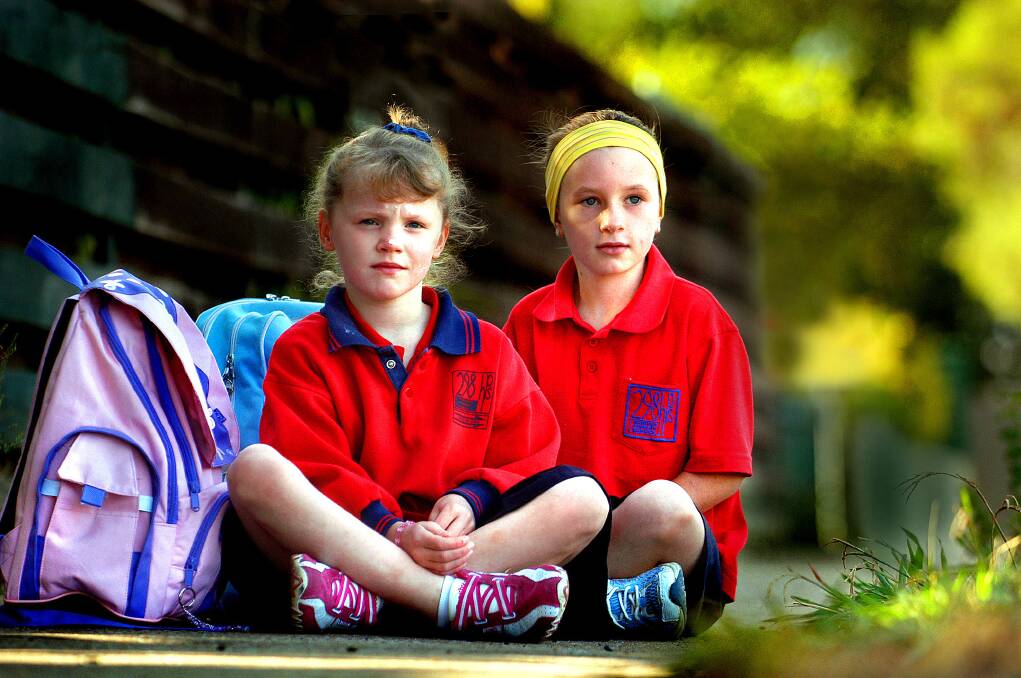 2006: Horsham 298 Primary School grade two student Ashleigh Miller and grade three student Taylah Klemm wait for the bus in Kalkee Road.