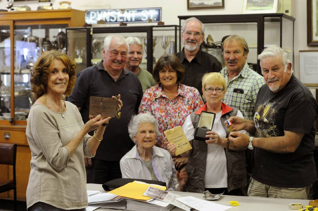 HOMECOMING: Walter Zumstein's granddaughter January Zeh, left, presents his war memorabilia to Horsham Historical Society, from left, Don Carter, January's husband Lance Wardlow, Marie Foley, Libby Peucker, Rod Jenkinson, Russell Peuker, Anne Wilksch and John Francis. Picture: PAUL CARRACHER