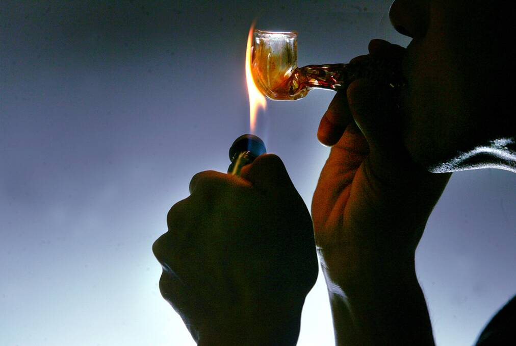 ICE: Someone smoking crystal methamphetamine, commonly known as ice. Picture: FILE PIC