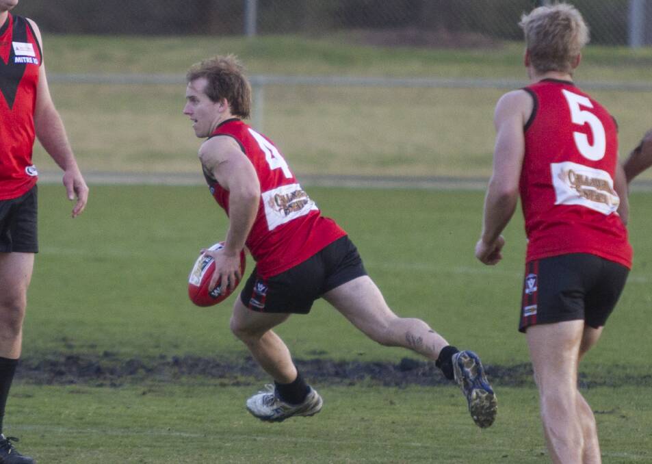 Player Cam Kimber looks to send the ball forward for Stawell.