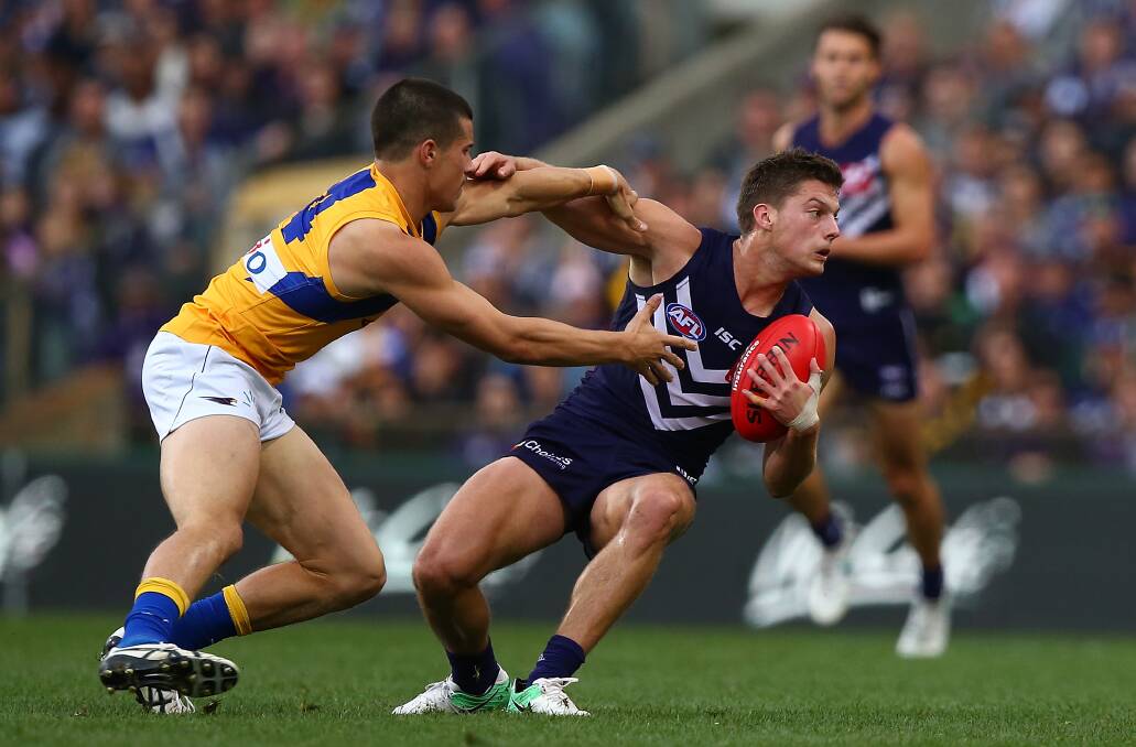 OPTION: Fremantle player Darcy Tucker looks to handball during his round 17 clash against West Coast. Picture: GETTY IMAGES