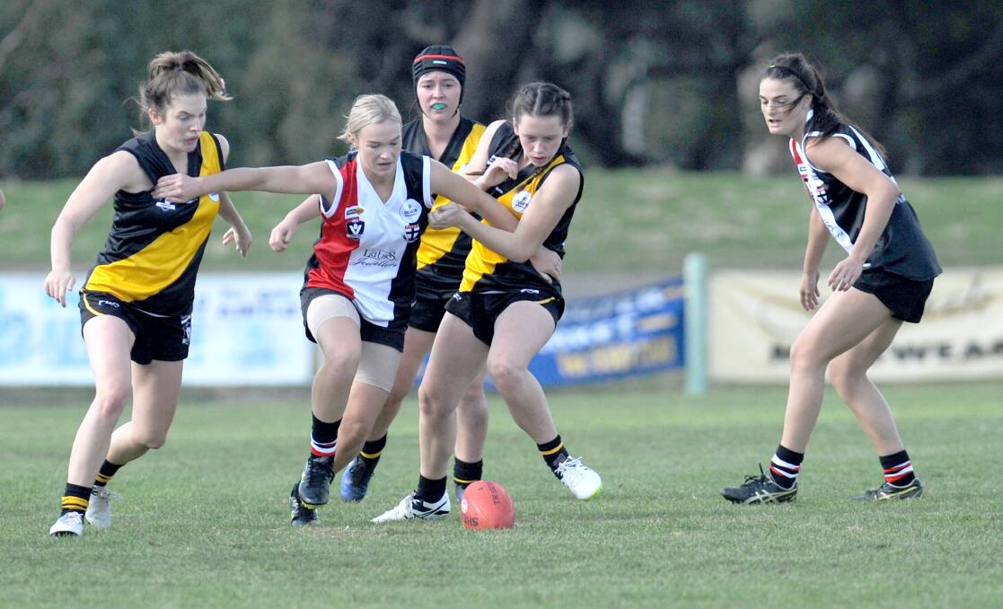 BARGE: Aily McAuliffe pushes her way through a pack of players in the second round Horsham Saints Female Football League encounter. Picture:OLIVIA PAGE