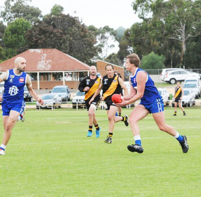 HANDS: Chris Prockter prepares to dish off against Sea Lake-Nandaly in round four. The Royal Blues will have a tough game opposed to Birchip-Watchem on Saturday. Picture: BULOOKE TIMES