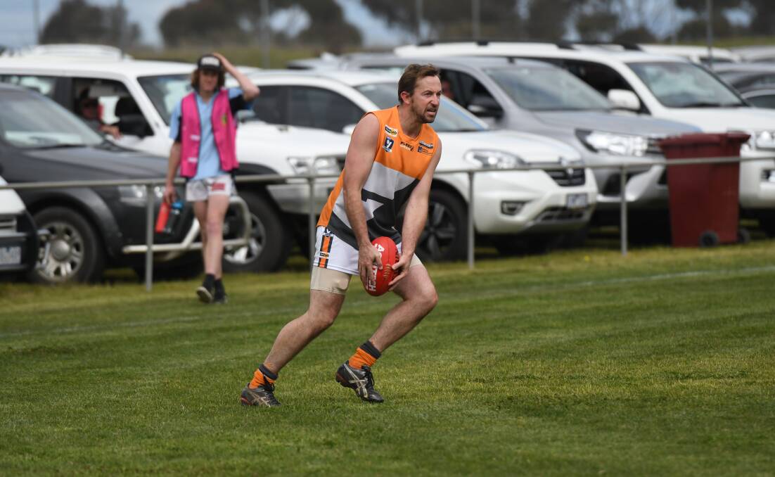 MOVEMENT: Jeremy Moore looks to get the ball moving forward for the Southern Mallee Giants reserves side in its preliminary final win. Pictures: SAMANTHA CAMARRI