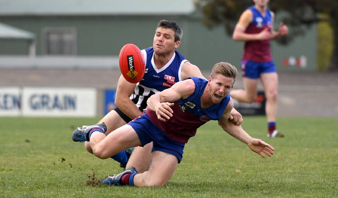 INTENSITY: Justin Garth applies pressure to Brad Hartigan during the second semi-final at Anzac Oval. Picture: SAMANTHA CAMARRI