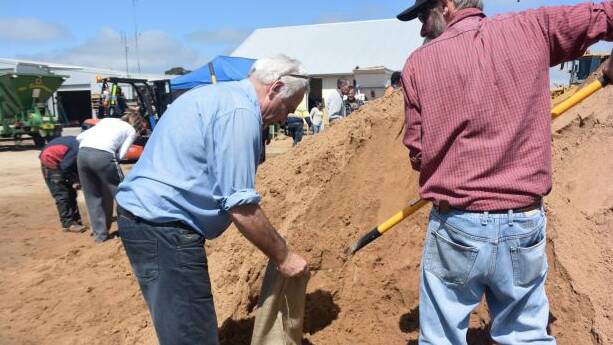 Forbes residents make sand bags with the SES in preparation for the flood. Photo: Olivia Grace-Curran