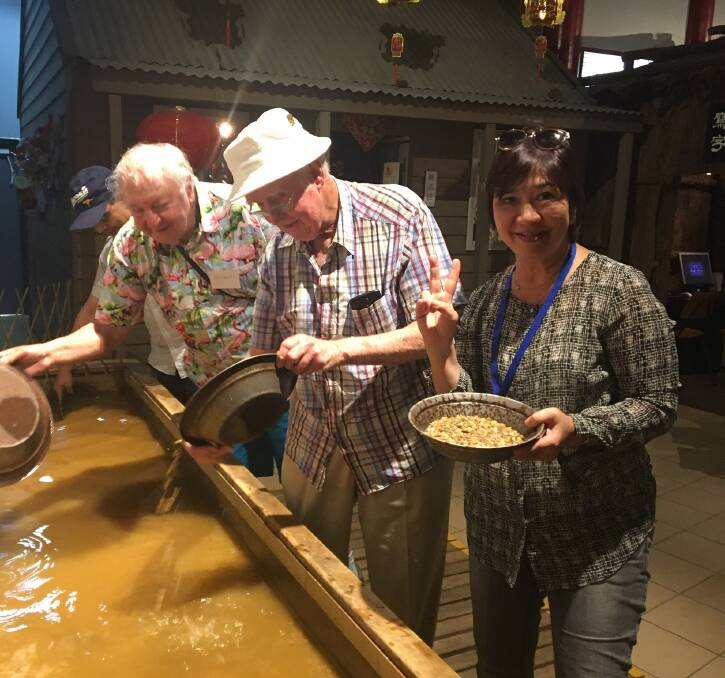 GOLD: Tour participants are pictured panning for gold at the Chinese Heritage Centre.